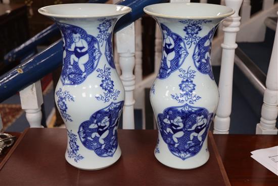 A pair of late 20th century Chinese blue and white boys vases H.34cm
